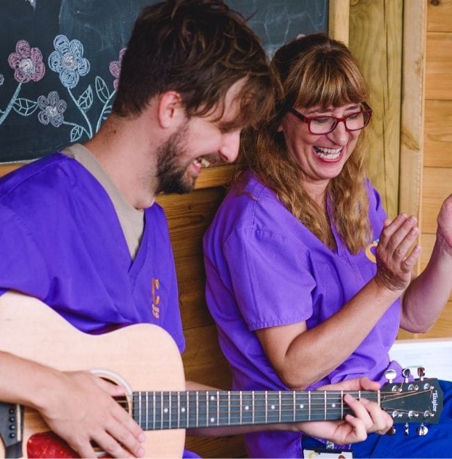 Jack and Elaine playing the guitar and singing
