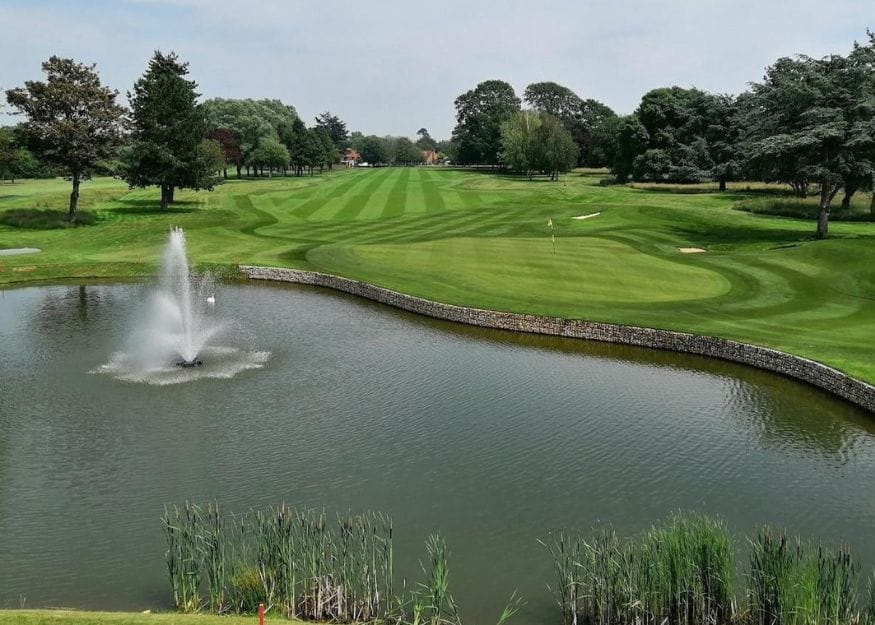 The golf course and pond at Ham Manor Golf Club
