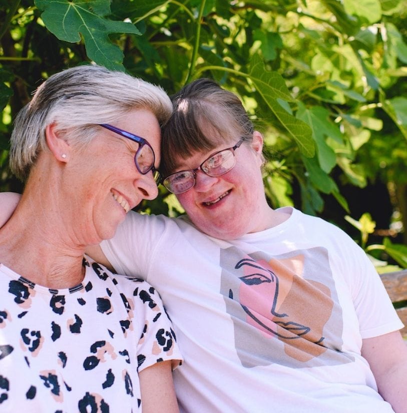 a patient at St Barnabas house sitting with her mum in the hospice garden